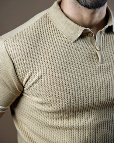 Textured knitted polo beige T-shirt with black trousers.