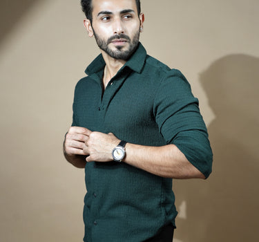 Causual body fit tapered dark green shirt with black trousers.