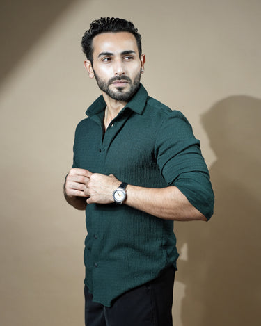 Causual body fit tapered dark green shirt with black trousers.