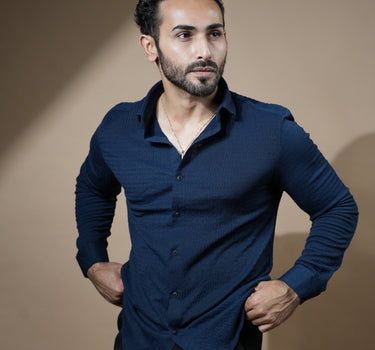 Causual body fit tapered navy blue shirt with black trousers.