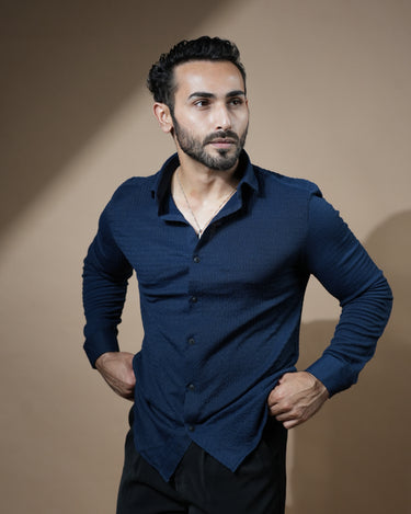 Causual body fit tapered navy blue shirt with black trousers.