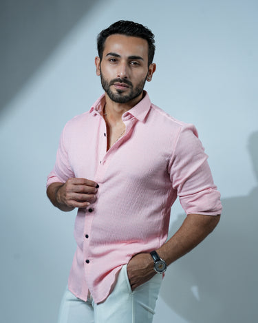 Causual body fit tapered pink shirt with white trousers.