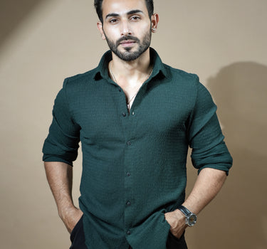 Causual body fit tapered dark green shirt with black trousers.