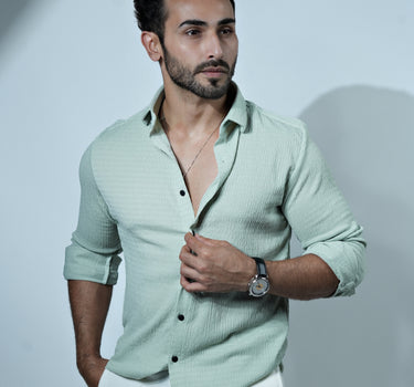 Causual body fit tapered green shirt with white trousers.