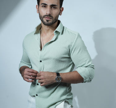 Causual body fit tapered green shirt with white trousers.