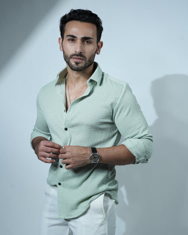 Causual body fit tapered green shirt with white trousers.
