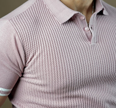 Textured knitted polo mauve T-shirt with black trousers.