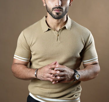 Textured knitted polo beige T-shirt with black trousers.