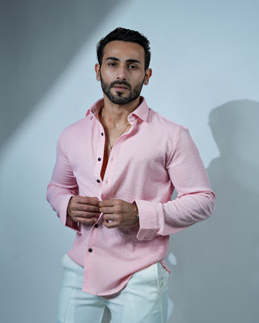 Causual body fit tapered pink shirt with white trousers.