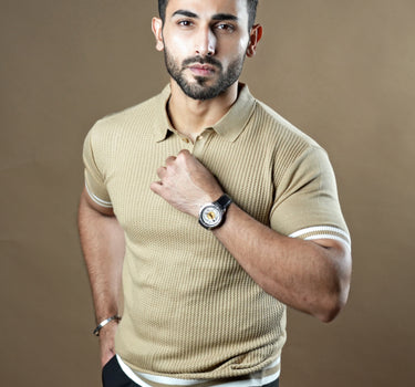 Textured knitted polo beige T-shirt with black trousers.