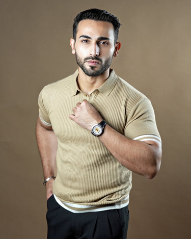 Textured knitted polo beige T-shirt with black trousers.