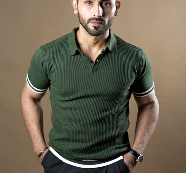 Textured knitted polo dark green T-shirt with black trousers.