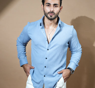 Causual body fit tapered light blue shirt with white trousers.