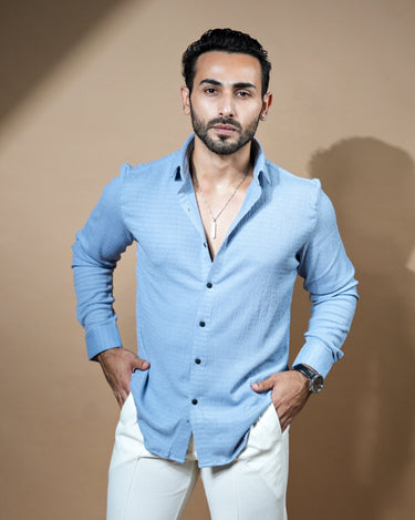 Causual body fit tapered light blue shirt with white trousers.