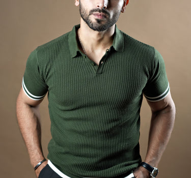 Textured knitted polo dark green T-shirt with black trousers.