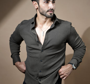 Causual body fit tapered brown shirt with black trousers.