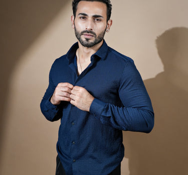 Causual body fit tapered navy blue shirt with black trousers.