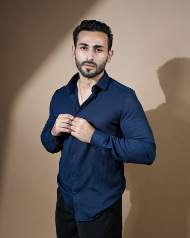 Causual body fit tapered navy blue shirt with black trousers.