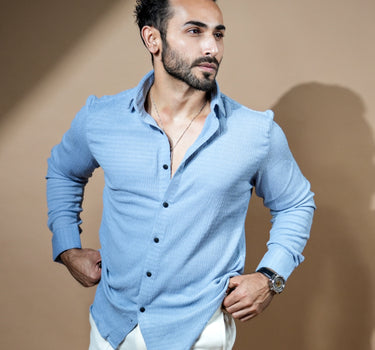 Causual body fit tapered light blue shirt with white trousers.