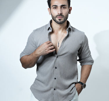 Causual body fit tapered jacquard grey shirt with white trousers.