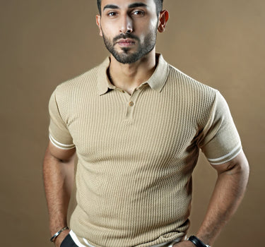 Textured knitted polo beige T-shirt with black trousers.