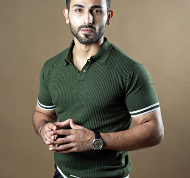 Textured knitted polo dark green T-shirt with black trousers.