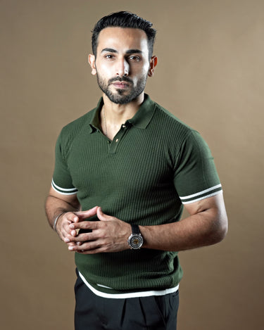 Textured knitted polo dark green T-shirt with black trousers.