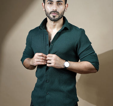 Causual body fit tapered dark green shirt with black trousers.